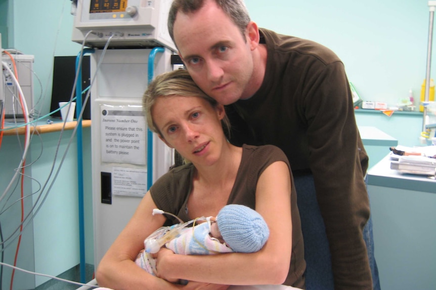 Sophie Smith cradles her baby boy, Jasper, who died 58 days after he was born. Her husband leans his head towards hers