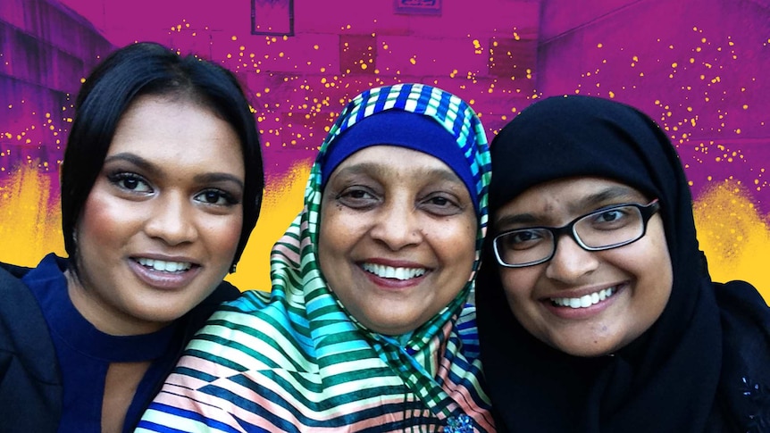 Three woman in front of a colourful pink and yellow background for a story about cooking in isolation during Ramadan.