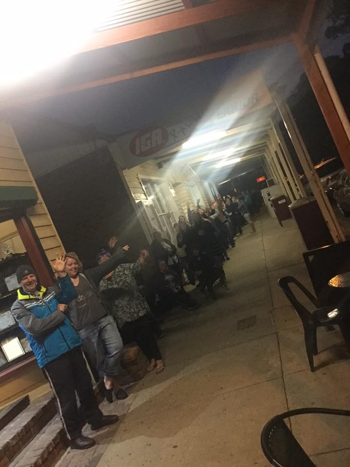 Crowds of hot cross bun hopefuls line-up in the main street of Glengarry, in Gippsland.