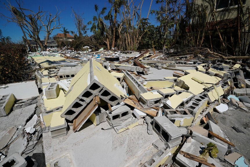 Destroyed homes lays on the ground in pieces.