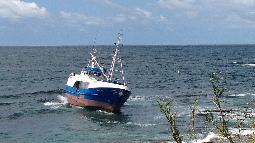 A fishing boat run aground on rocks at Cronulla Point in Sydney's south.