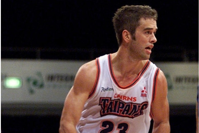 Anthony Stewart on the basketball court bouncing a ball.