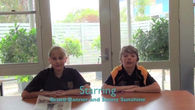 Two school students sit behind desk, text on screen reads "Starring Bruce Banner and Sunny Sunshine"