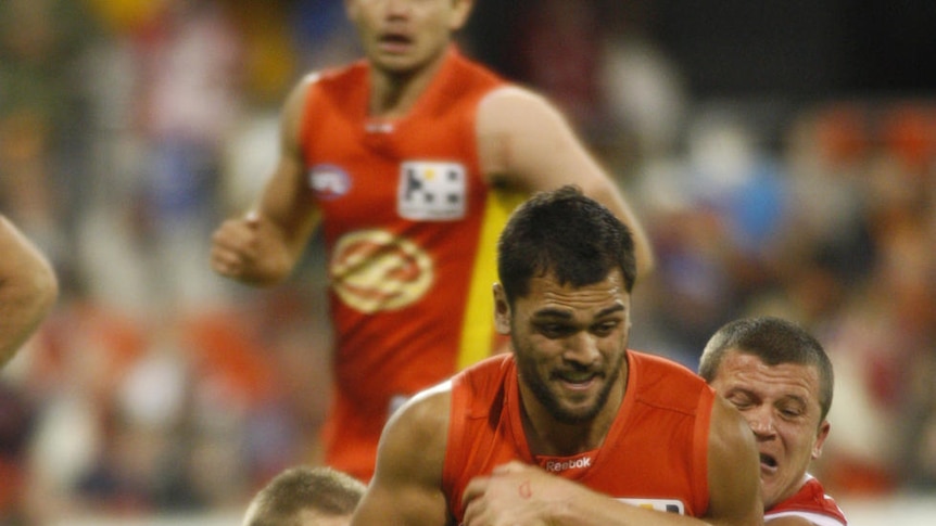 Crushed: Karmichael Hunt is pulled down by Jarred Moore in another massive Suns loss.
