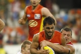 Crushed: Karmichael Hunt is pulled down by Jarred Moore in another massive Suns loss.