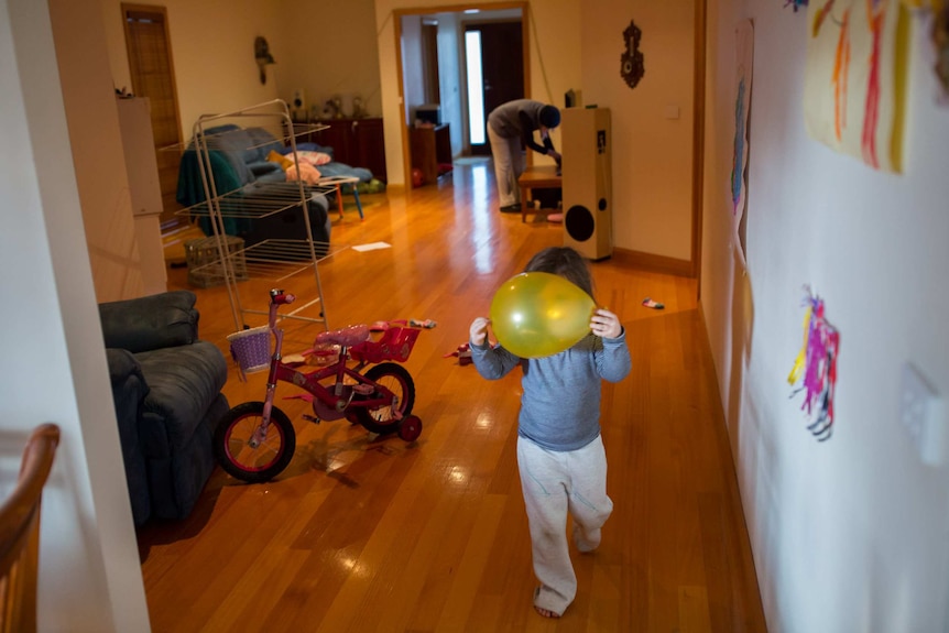Jayde plays with a balloon inside her grandmother's house.