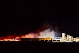A fire at night at an almond processing facility.