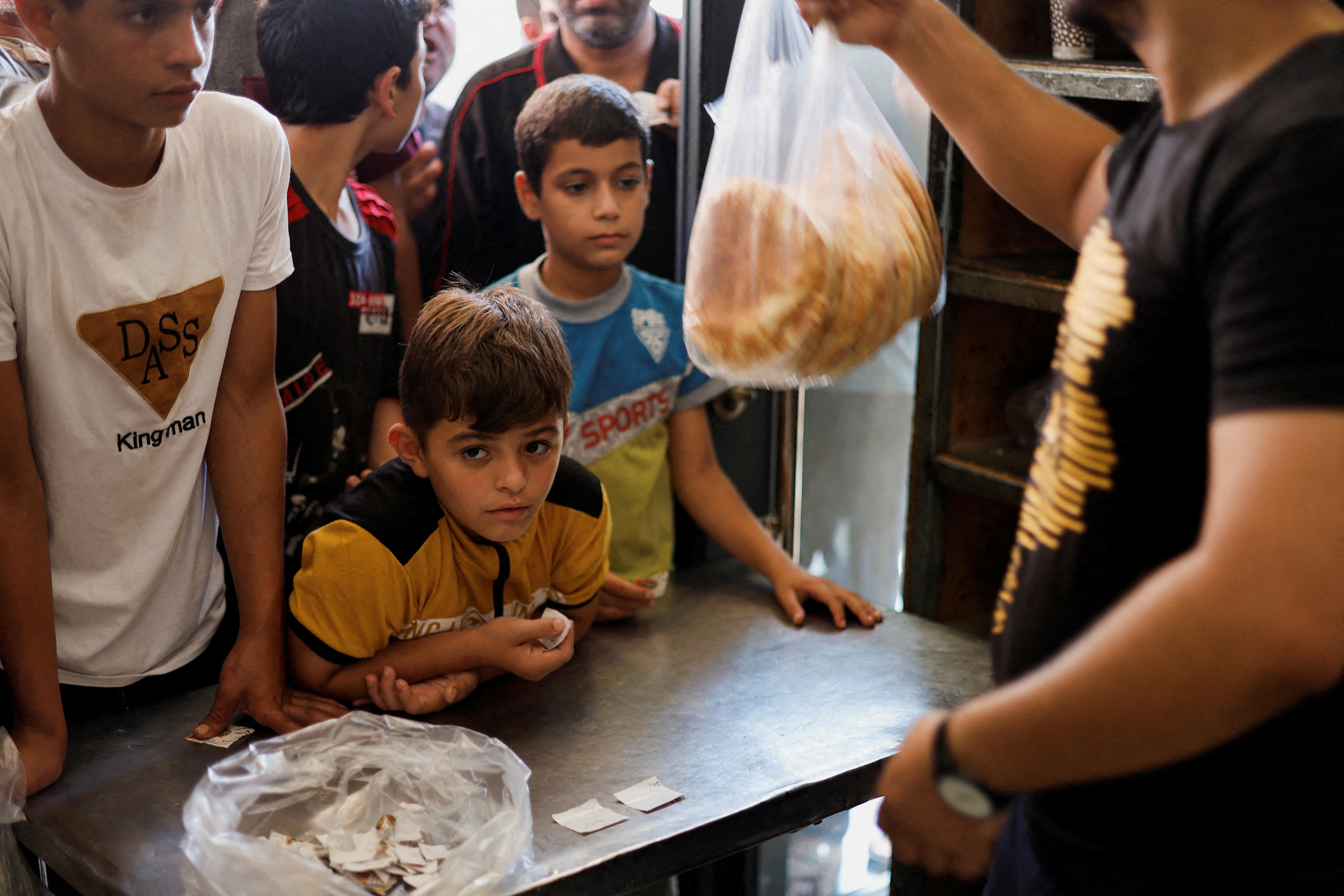 kids lines up to buy bread 