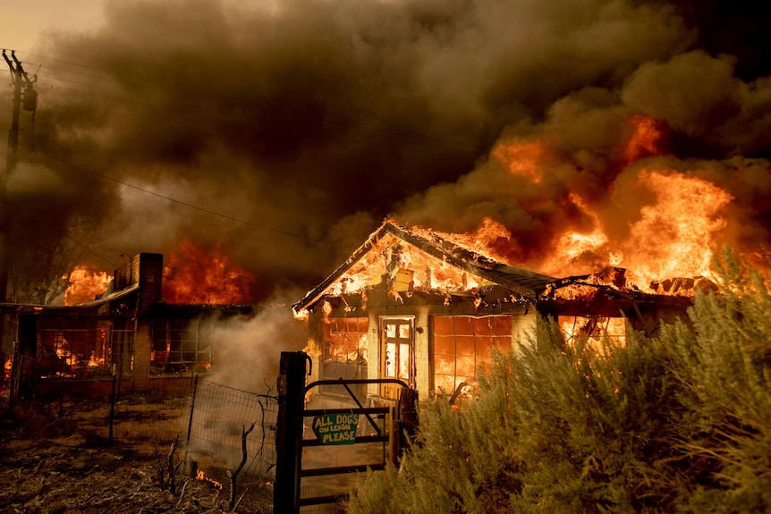 A small house engulfed in flames 