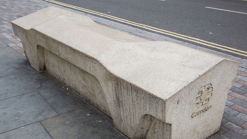 A concreate bench with an uneven surface designed to prevent people sleeping on it.