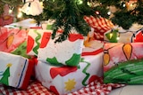 Homemade wrapping paper used on Christmas presents under a tree.