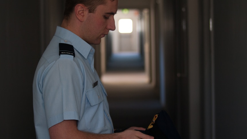 FLGOFF Shane Ivimey looking at hat his RAAF hat emblem at the Edinburgh RAAF Base near Adelaide.