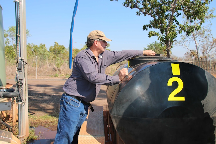 A man fills up a large water container