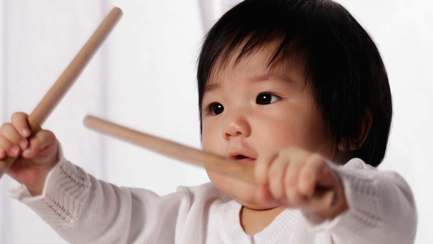 Baby girl playing drum