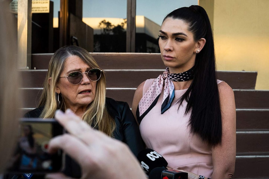 Two women, a mother, and a daughter, speaking to reporters outside a courthouse