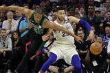 Ben Simmons struggles to get the basketball as Al Horford reaches around him.