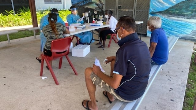 People sitting and waiting for a Covid-19 test on Palm Island