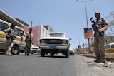 Yemeni soldiers guard a checkpoint in the city of Taez