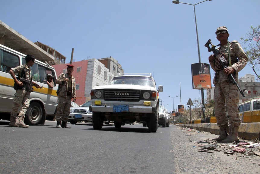 Yemeni soldiers guard a checkpoint in the city of Taez