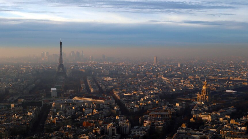 The Eiffel Tower and The Invalides dome surrounded by air pollution