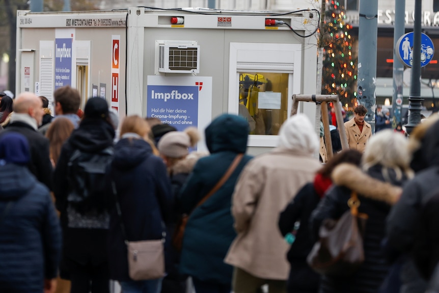 People line up in front of a vaccination centre in Vienna 