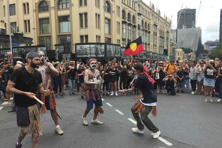 Clap sticks and dancing on the road with big crowds.