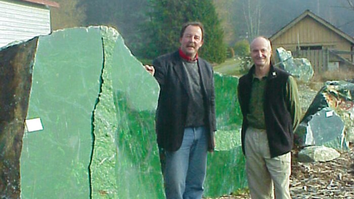 Ian Green standing beside the massive boulder of Nephrite Jade.
