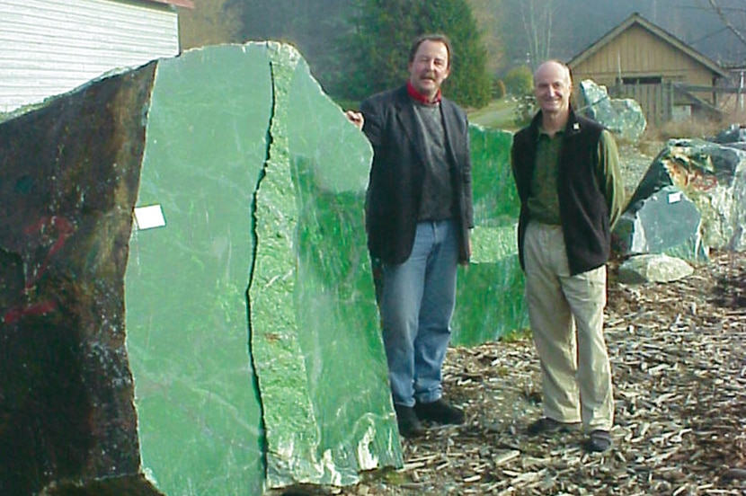 Ian Green standing beside the massive boulder of Nephrite Jade.