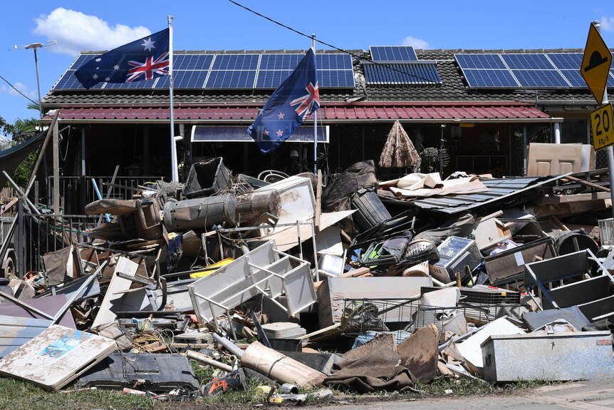 Australian flag hangs upside down outside a home in Goodna after the February flood.