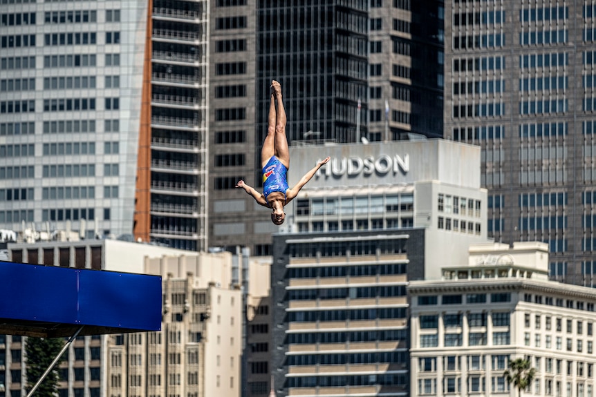 Rhiannan Iffland dives in front of buildings