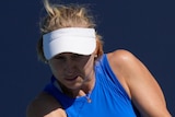 An Australian female tennis player hits a backhand at the Miami Open.