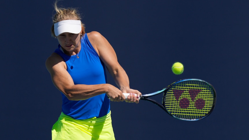 An Australian female tennis player hits a backhand at the Miami Open.