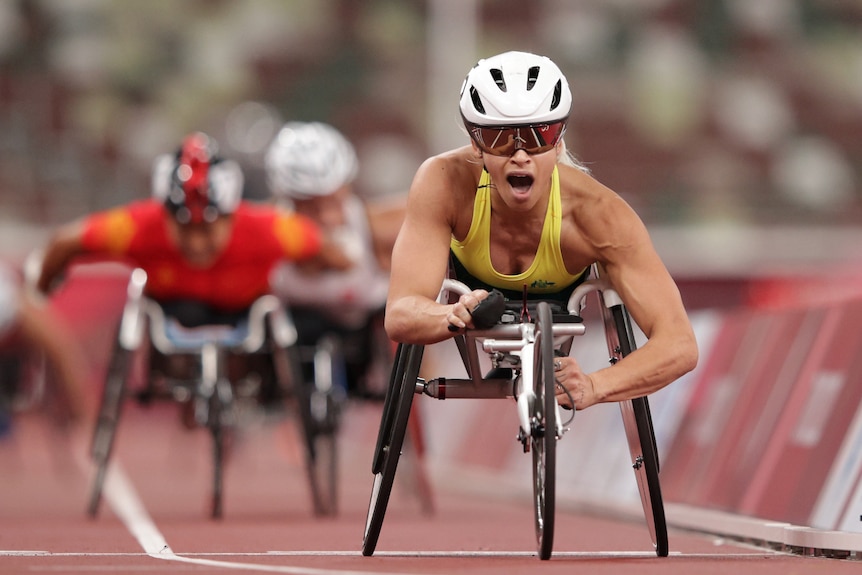 An Australian female wheelchair athlete crosses the line in first place at the Tokyo Paralympic Games.