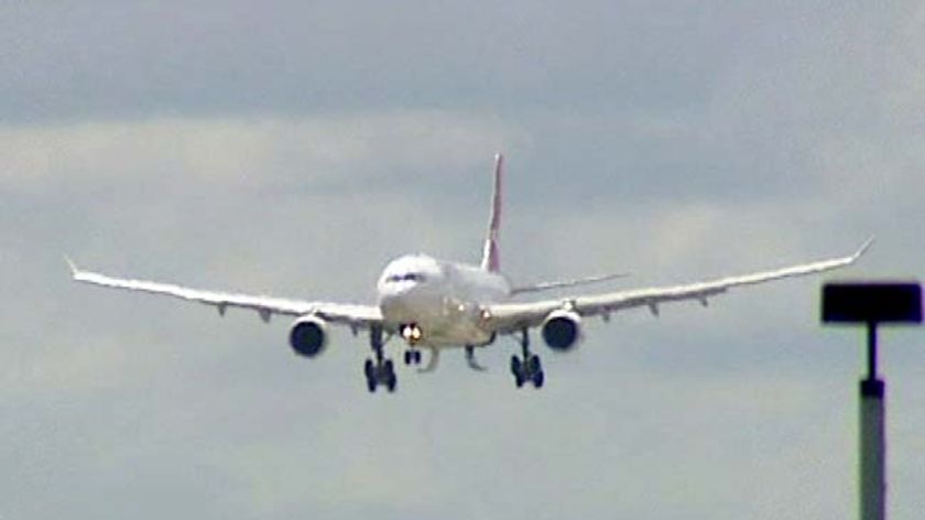 Qantas plane with landing gear trouble approaching the runway at Sydney airport