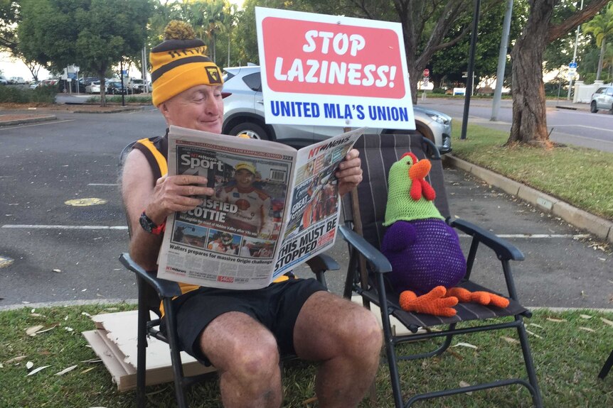 Independent Member for Nelson Gerry Wood protests with signs and a stuffed chook