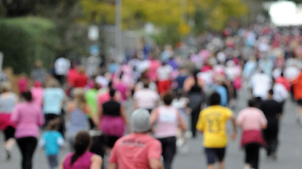 Kids look out for their mum amongst runners in Melbourne taking part in the Mother's Day Classic fun run