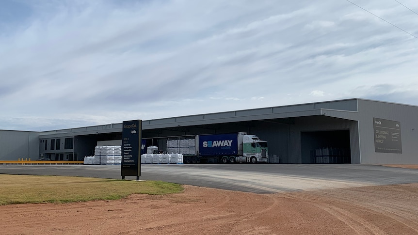 A large packing shed and offices. There's Grape Co signs on the side of the shed and on the roadside