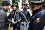 Russian police perform security checks on a photographer in Sochi.