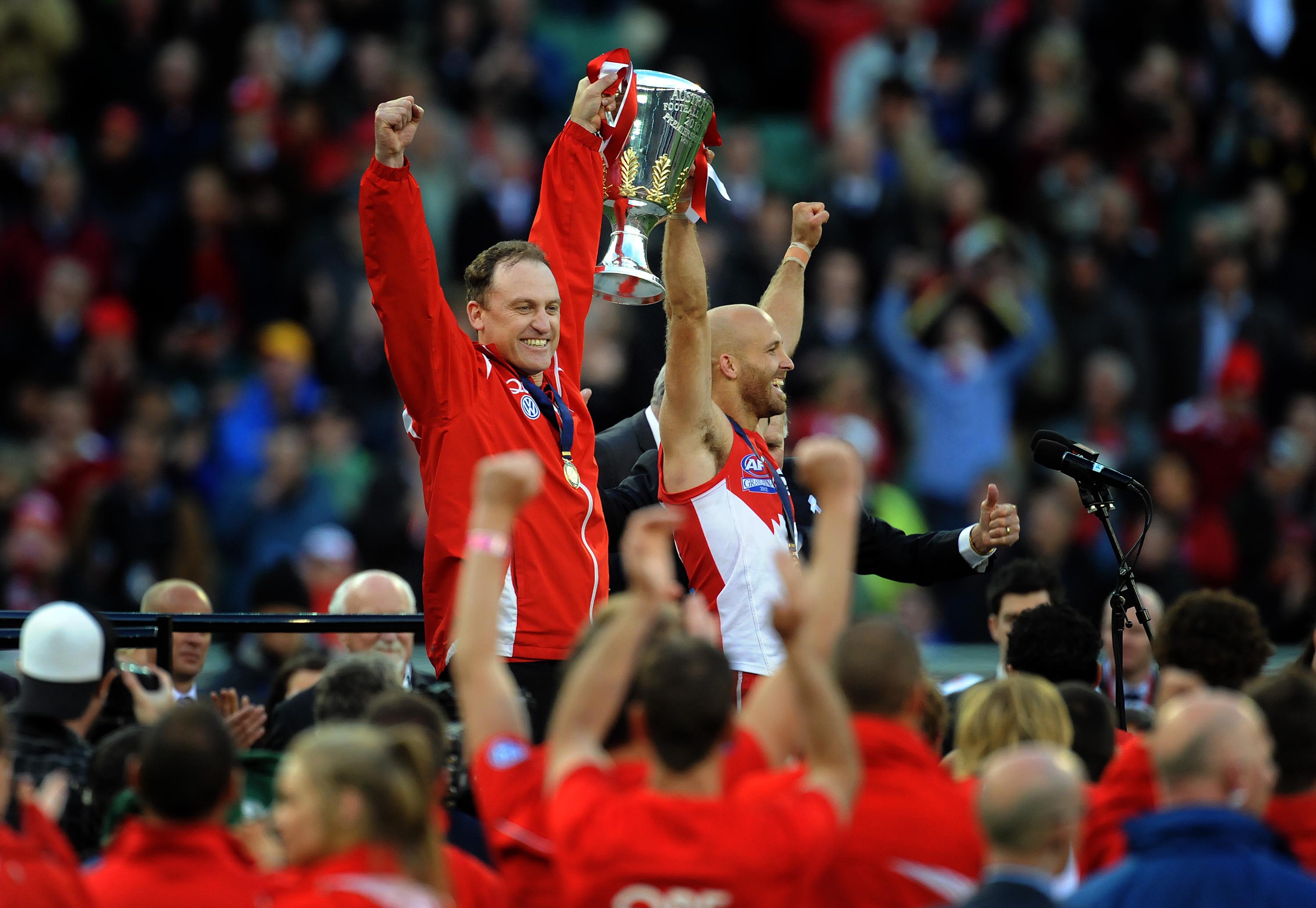 Sydney Swans coach John Longmire and captain Jarrad McVeigh hold the premiership cup.