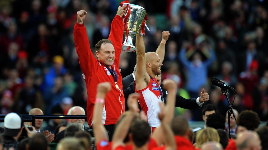 Sydney Swans coach John Longmire and captain Jarrad McVeigh hold the premiership cup.