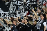 Collingwood fans celebrate a goal