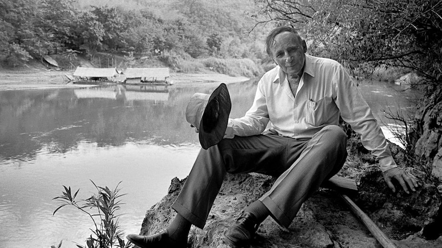 Weary Dunlop sits on the bank of the River Kwai.