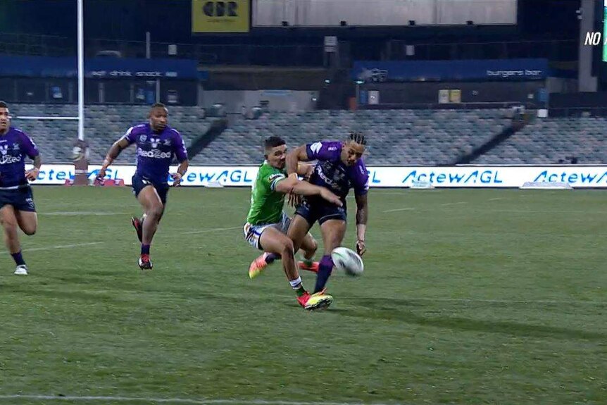 A screenshot of Raiders winger Bailey Simonsson and Storm winger Josh Addo-Carr competing for the ball.