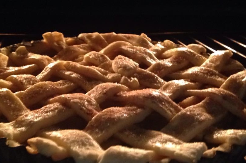 lattice work on top of an apple pie in the oven