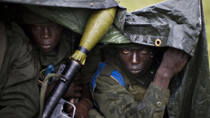 Government troops shelter from the rain in the Democratic Republic of Congo