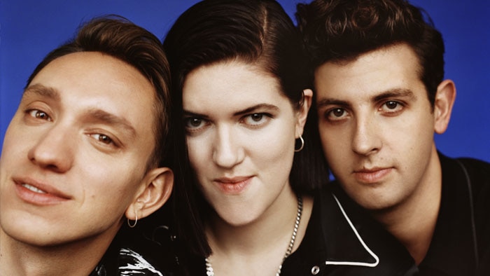 A 2017 press shot of The xx in profile: Oliver Sims, Romy Madley Croft, and Jamie xx lined up in close-up