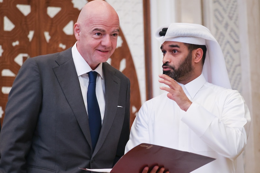 Gianni Infantino and Hassan Al Thawadi speak to each other
