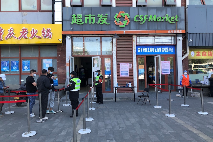 People line up for their vaccination in Beijing in April. 