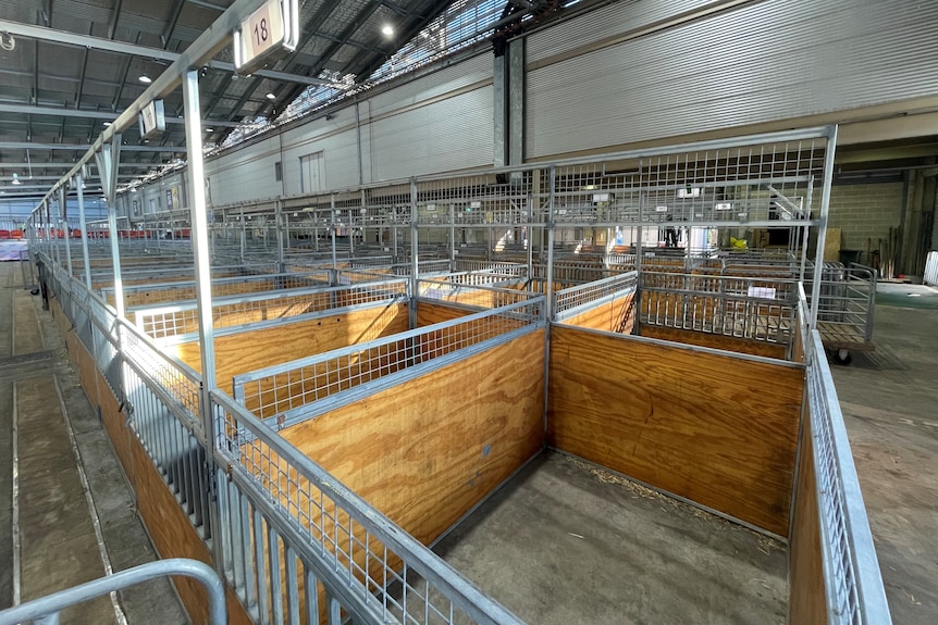 Empty animal pens in a pavilion.