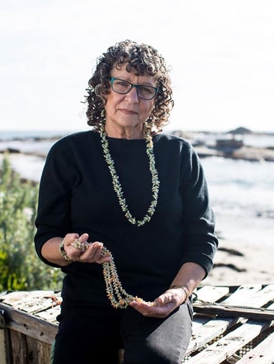 Tasmanian Aboriginal elder Vicki-Laine Green holding the necklaces she has made.